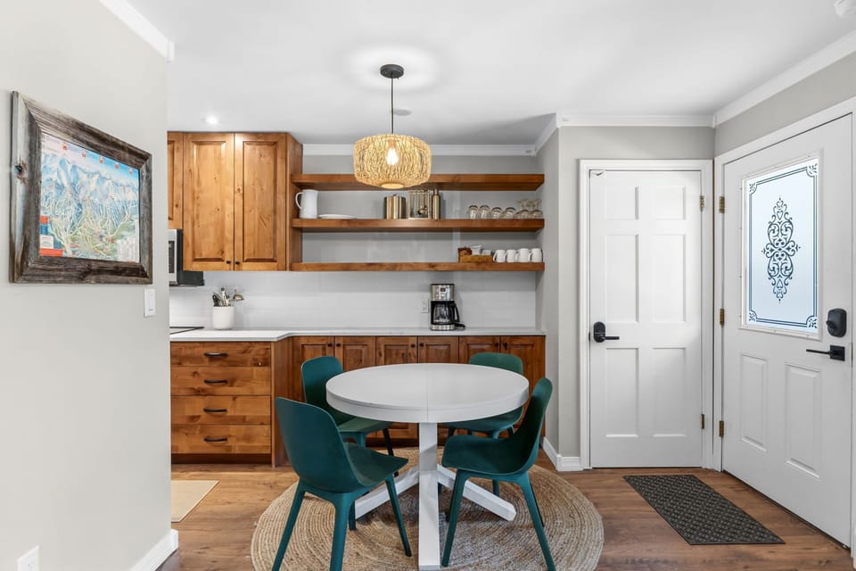 Step into your bright, welcoming kitchen and dining space, where warm wood tones and open shelving invite you to gather around the cozy table for meals and morning coffee.