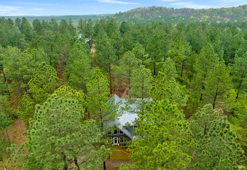 Surrounded by towering trees, the cabin's peaceful setting offers the perfect balance of privacy and easy access to all the adventures of Hochatown.