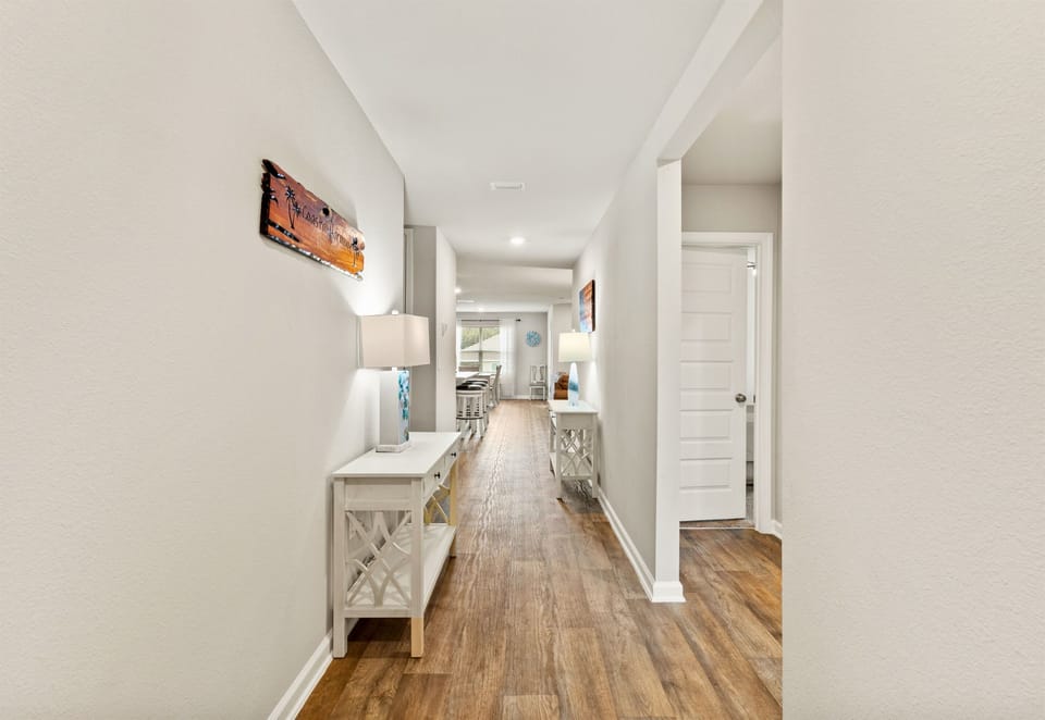 Inviting hallway that flows easily through this coastal home, connecting bedrooms, living, and dining areas.