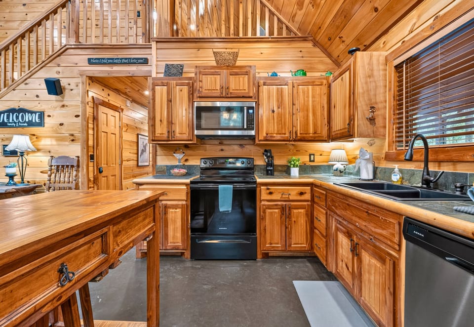 Fully equipped for your stay, this kitchen offers plenty of room to prepare meals while still being part of all the fun happening throughout the cabin.