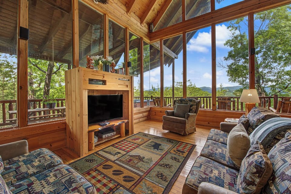 Relax in your sun-drenched living room with vaulted ceilings, cozy fireplace, and floor-to-ceiling windows framing lush mountain views from every angle.