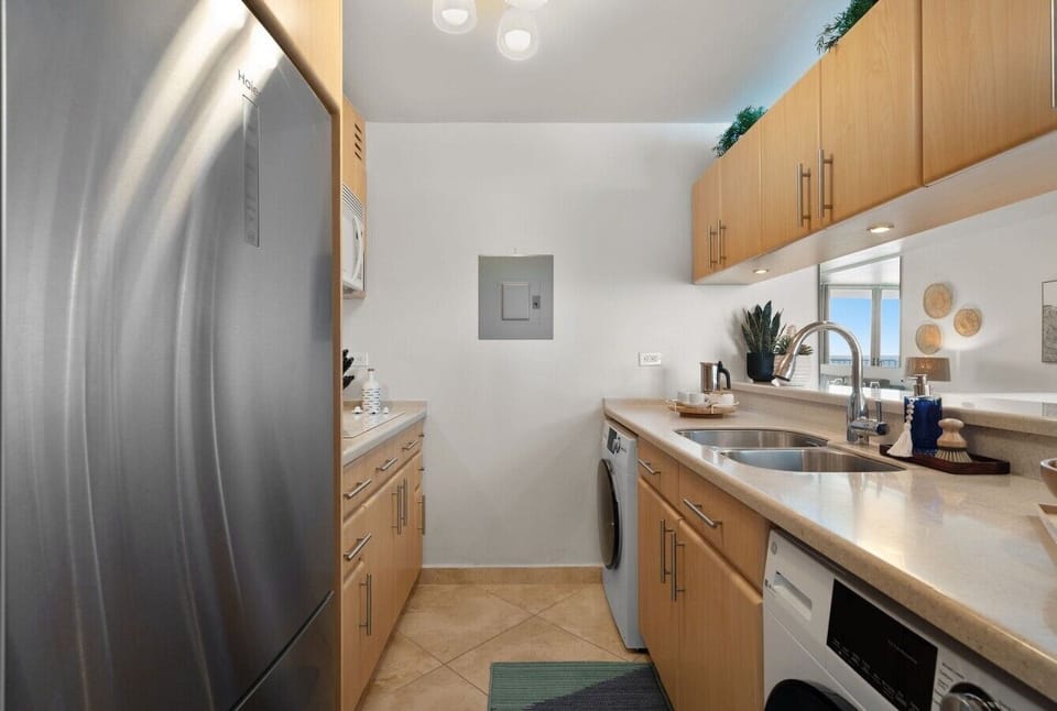 open kitchen with coastal décor and ocean views reflected throughout.
