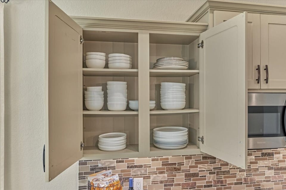 Kitchen cabinet storage stocked with dishes for easy meals.