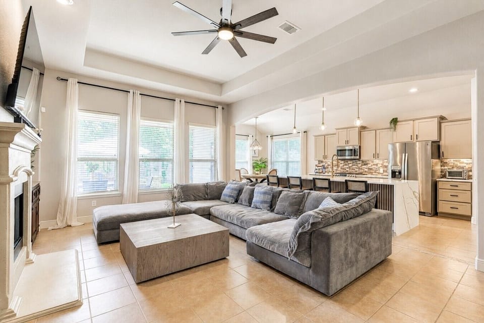 Open living room and kitchen with sectional seating and island views.