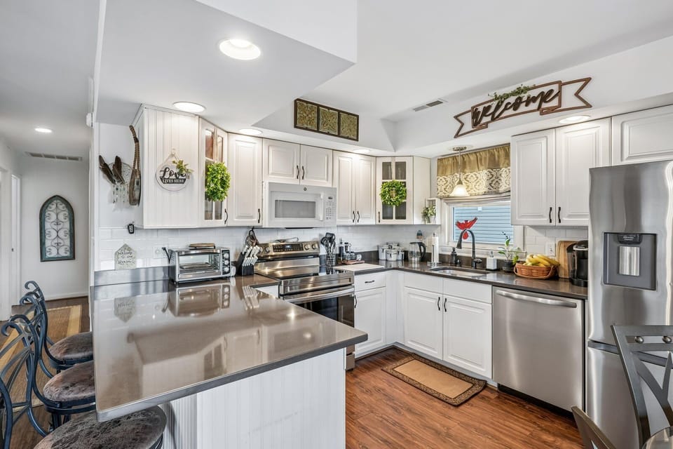 Step into this bright, fully-equipped kitchen with stainless appliances, spacious counters, and cheerful touches—your inviting space to cook, gather, and create memories.