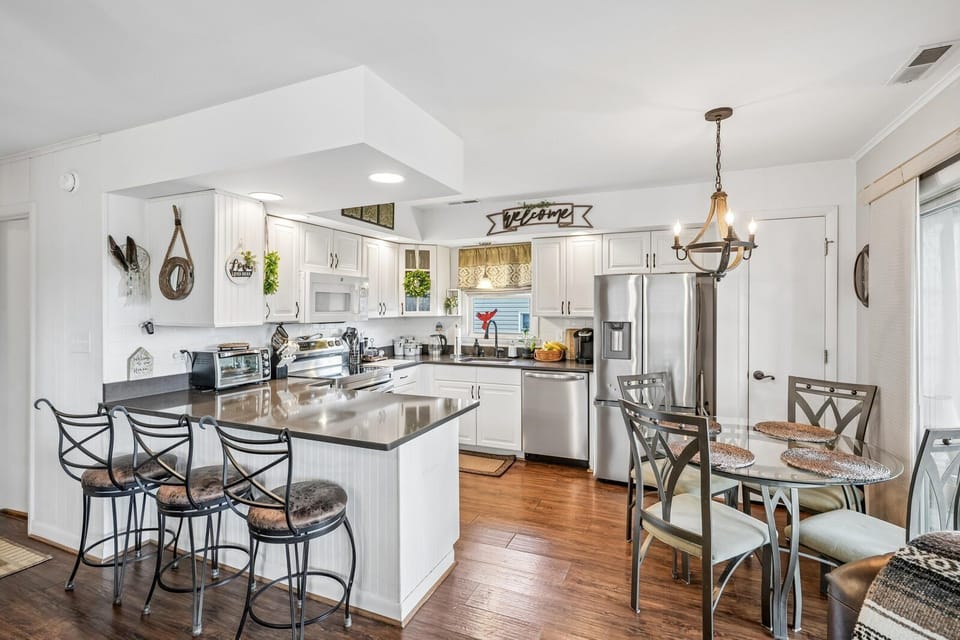 Step into a bright, open kitchen with gleaming countertops, stainless appliances, and a welcoming breakfast bar where you can enjoy your morning coffee or plan your day's adventures.