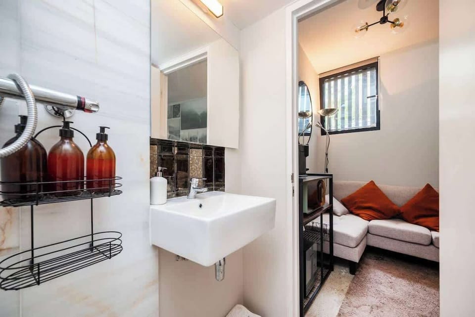 The bathroom is a full wet room, so when you shower, the whole room will get wet. This is owing to the compactness of this space. 