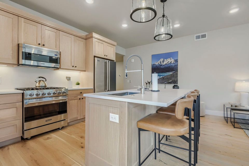 Your fully equipped kitchen invites culinary adventures with sleek stainless steel appliances, a spacious island, and custom cabinetry—everything you need to cook and gather comfortably.