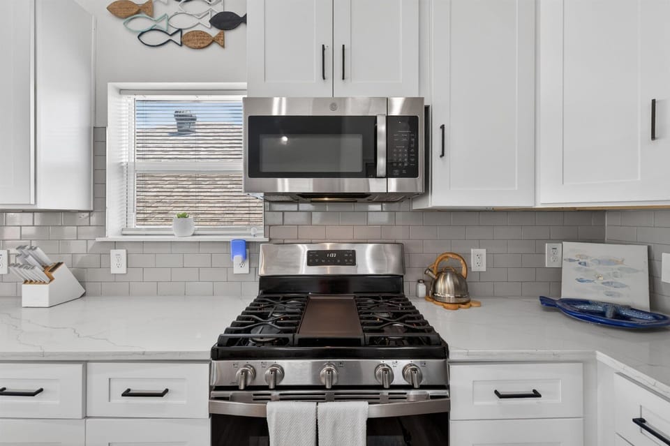 Well-equipped kitchen with modern stainless appliances.