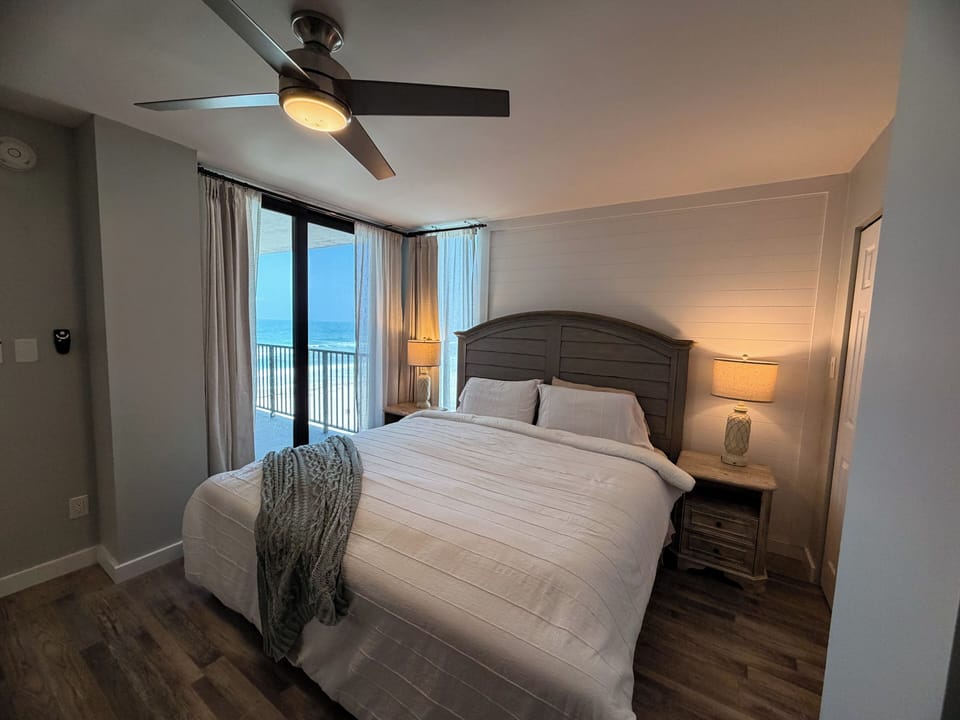Primary bedroom, king bed, walk-in closet, private slider to Gulf-view balcony, ceiling fan, USB-charging lamps