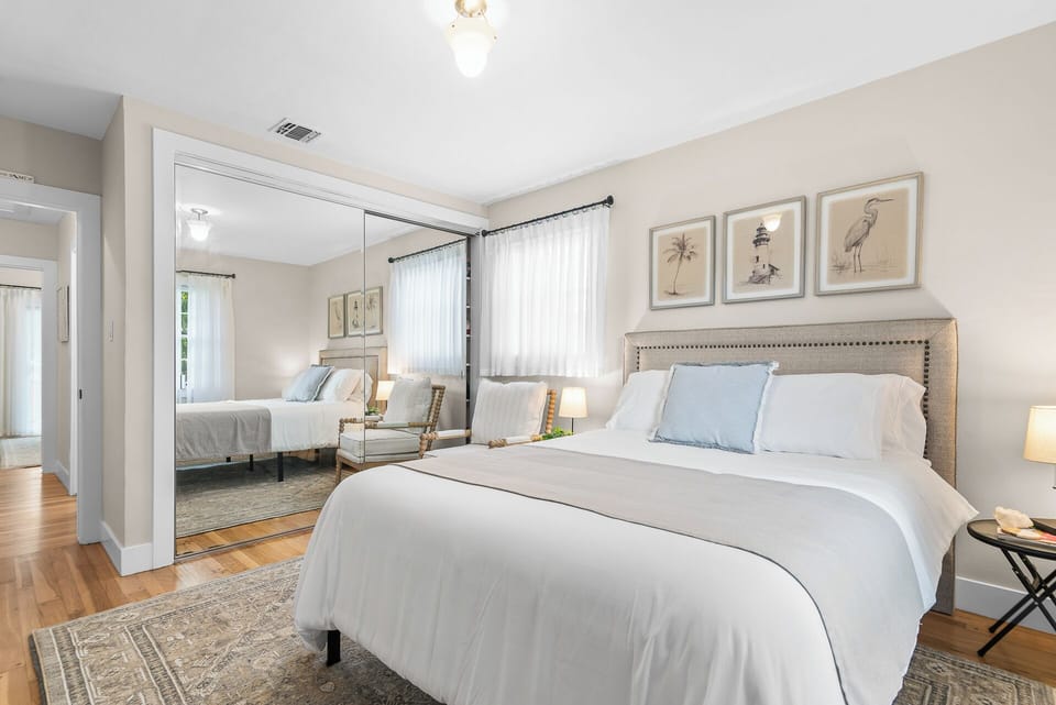 Relax in the thoughtfully appointed guest bedroom, complete with a queen bed, cozy reading chair, and peaceful natural light.