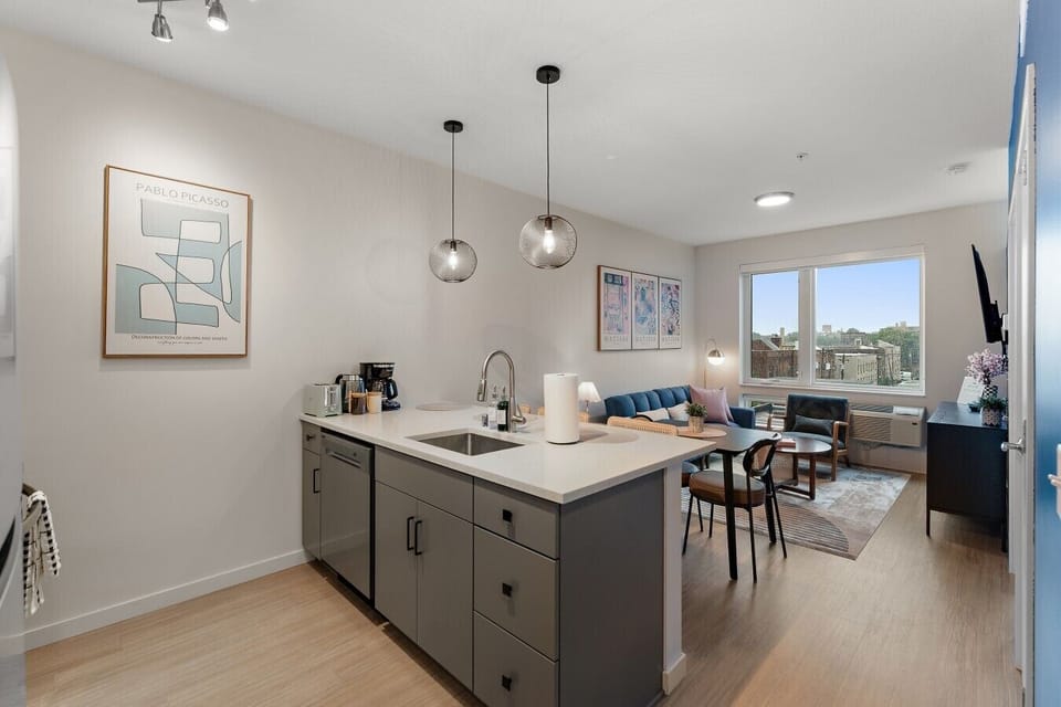 Open-concept kitchen, dining, and living area with modern finishes, natural light, and a cozy space to cook, dine, work, and unwind.