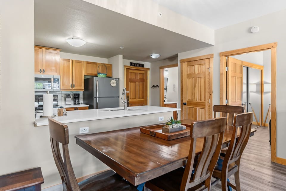Gather around the spacious dining table after a day of adventure, with a fully-equipped kitchen ready for your home-cooked meals and plenty of counter space for morning coffee.