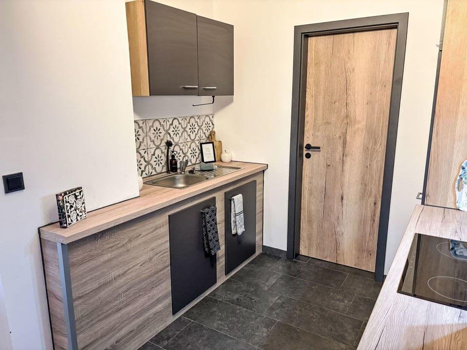 Wood, Flooring, Countertop, Floor, Furniture, Cabinetry, Room, Kitchen, Wood Stain, Hardwood