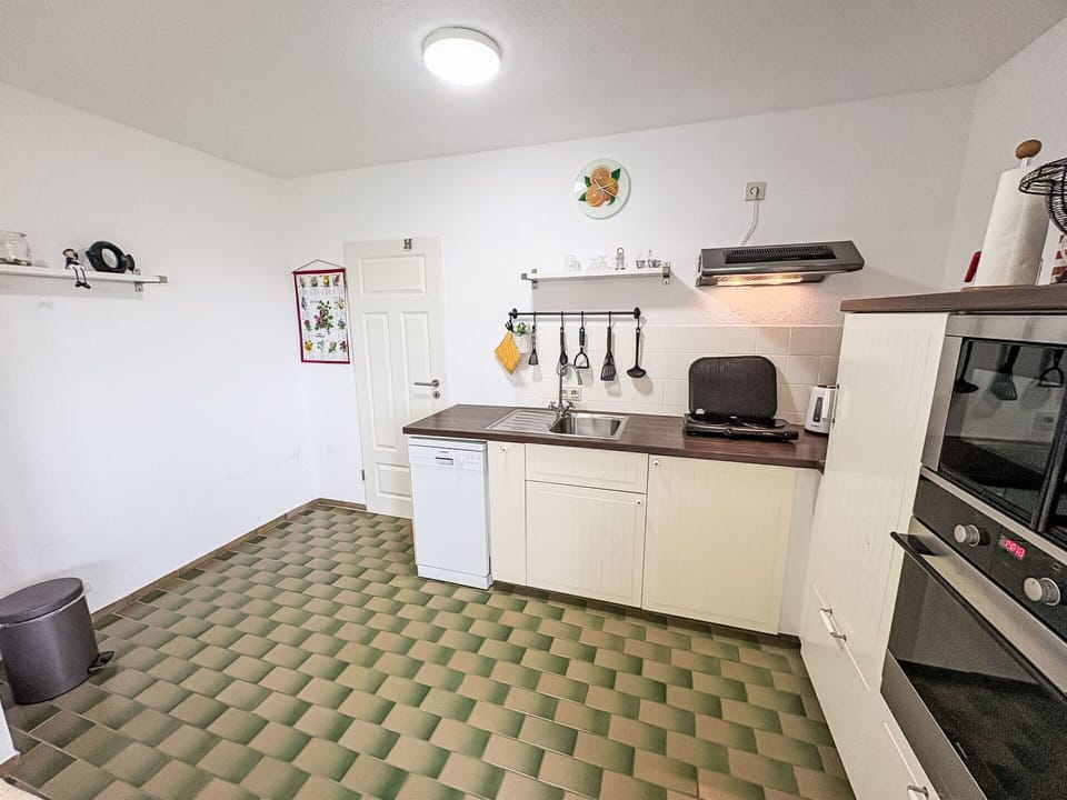 Flooring, Floor, Kitchen, Wood, Kitchen Appliance, Major Appliance, Interior Design, Kitchen Stove, Cabinetry, Countertop