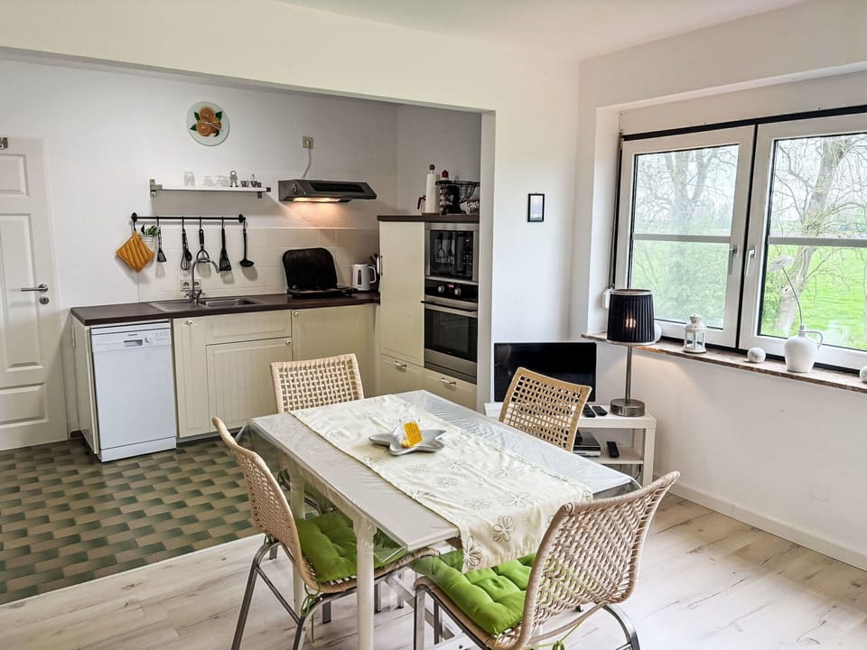 Furniture, Interior Design, Flooring, Kitchen, Floor, Wood, Countertop, Kitchen Appliance, Chair, Kitchen & Dining Room Table