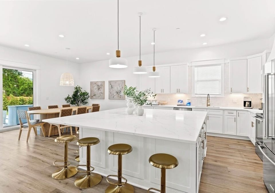 1st Floor - Fully stocked gourmet chef’s kitchen with stainless steel appliances, spacious island seating, and everything needed to prepare meals for large groups. The perfect gathering place for cooking, dining, and making vacation memories together.