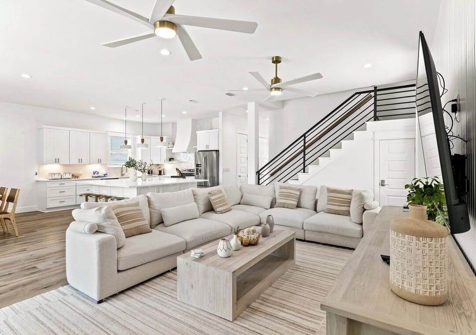 1st Floor - Gather in the spacious open-concept great room featuring comfortable lounge seating, abundant natural light, and a 75” 4K Smart TV. Seamlessly connected to the gourmet kitchen and dining area, it’s the perfect space for family gatherings.