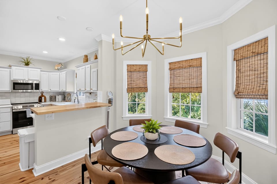 Dining table for 6 in kitchen plus extra dining seats in living area.