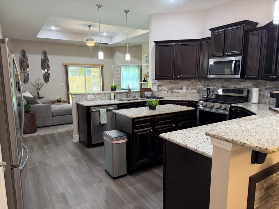 Spacious open kitchen with granite counters and stainless appliances