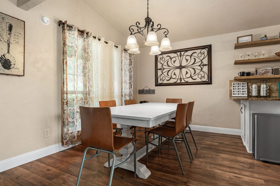 8 person dining table by open space kitchen and huge windows