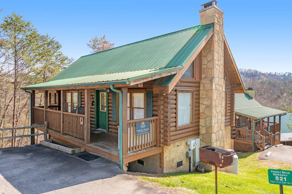 Charming Cabin Exterior, rustic wood and stone blend with a vibrant green roof, inviting adventure!