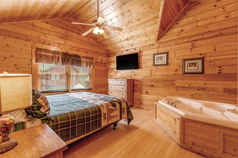 Charming Bedroom Retreat, rustic wood accents and a relaxing jacuzzi invite serene escapes!