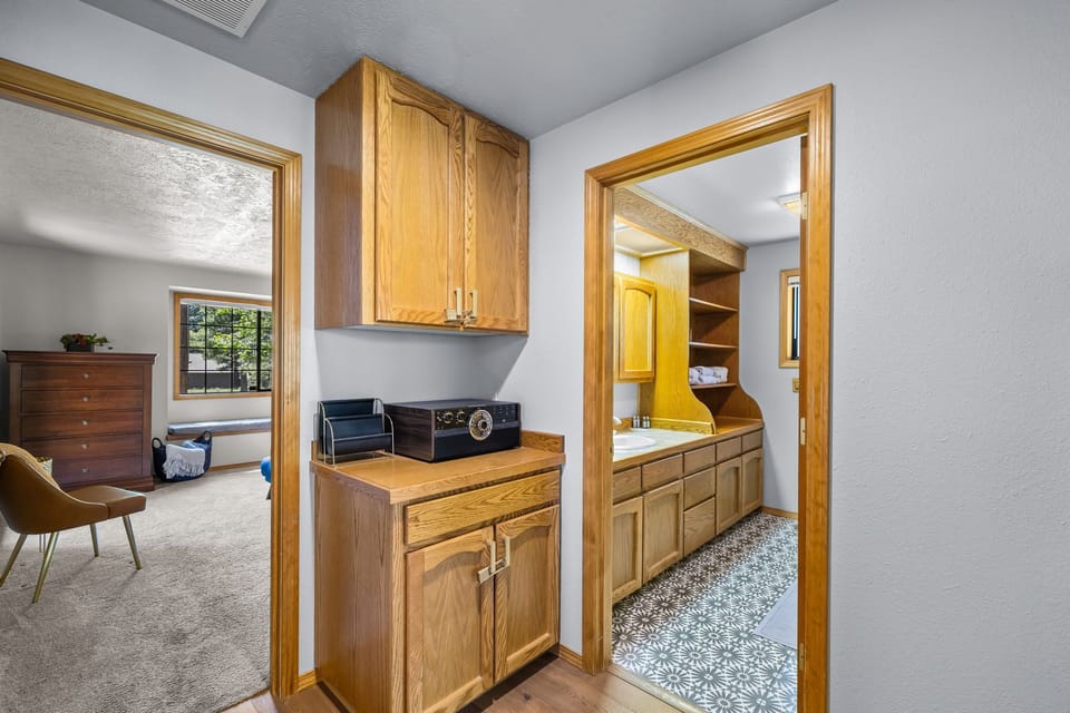A convenient laundry nook with washer and dryer connects your cozy bedroom to a well-appointed bathroom, making daily routines effortlessly easy during your stay.