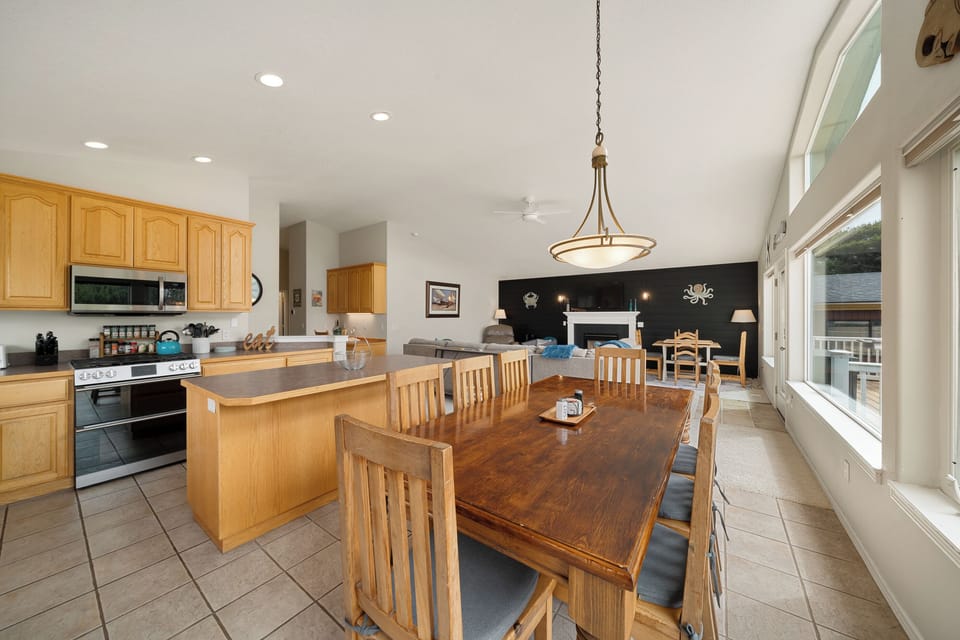 Gather around the spacious dining table where mornings start with laughter and evenings wind down over home-cooked meals, all in this bright, open-plan kitchen and living space.