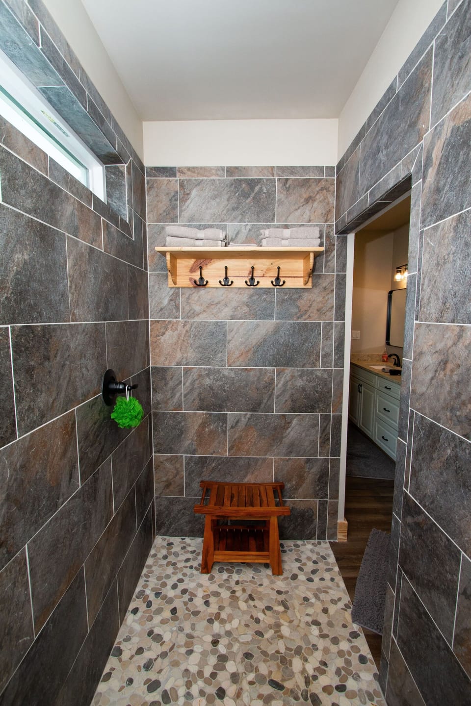 Huge walk-in shower with lots of storage and a bench