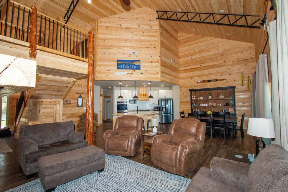 Vaulted living room, open floor plan leading into kitchen and dining area
