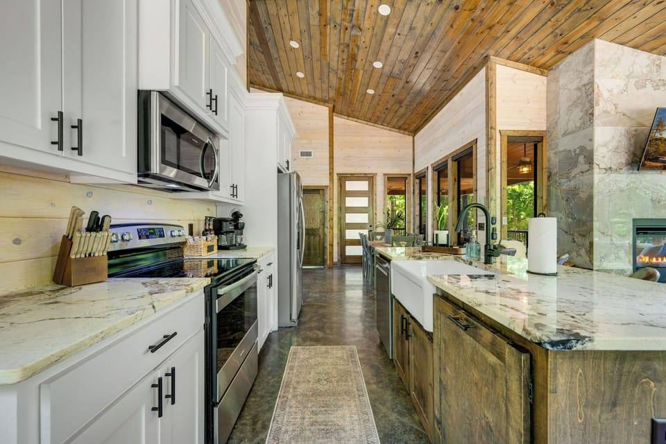 Stylish gourmet kitchen with vaulted wood ceilings and a spacious island