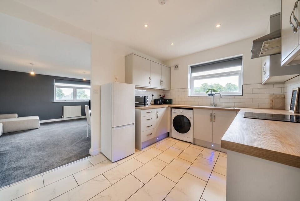 Sleek modern kitchen flowing into the living area, fully equipped for easy stays