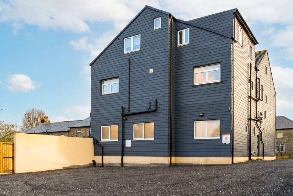 Spacious rear with private parking and contemporary slate-clad styling