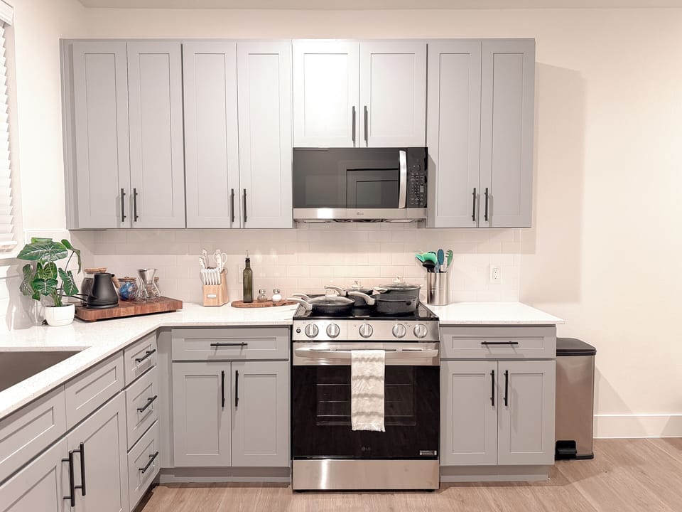 Bright modern kitchen with gas range, ample storage, and sleek finishes