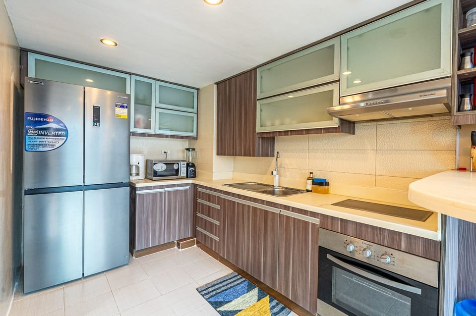 Modern kitchen with wood cabinets, frosted glass, and appliances — bright space.