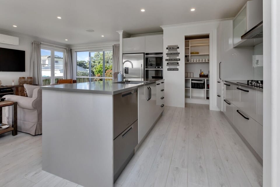 Fully equipped modern kitchen with large island and walk-in pantry