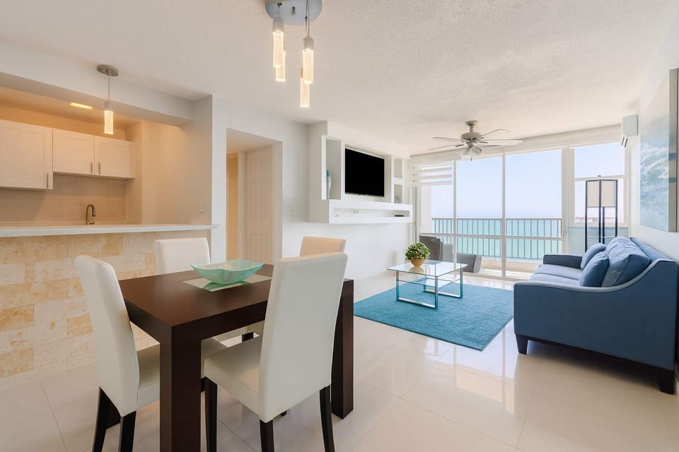 Stylish open-concept apartment with ocean views. Features a modern kitchen, cozy dining area, and bright living space that opens to the balcony—perfect for relaxing or enjoying meals with a view.