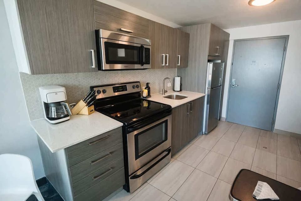 Fully equipped modern kitchenette with stainless steel appliances and everything needed for convenient meals during your stay.