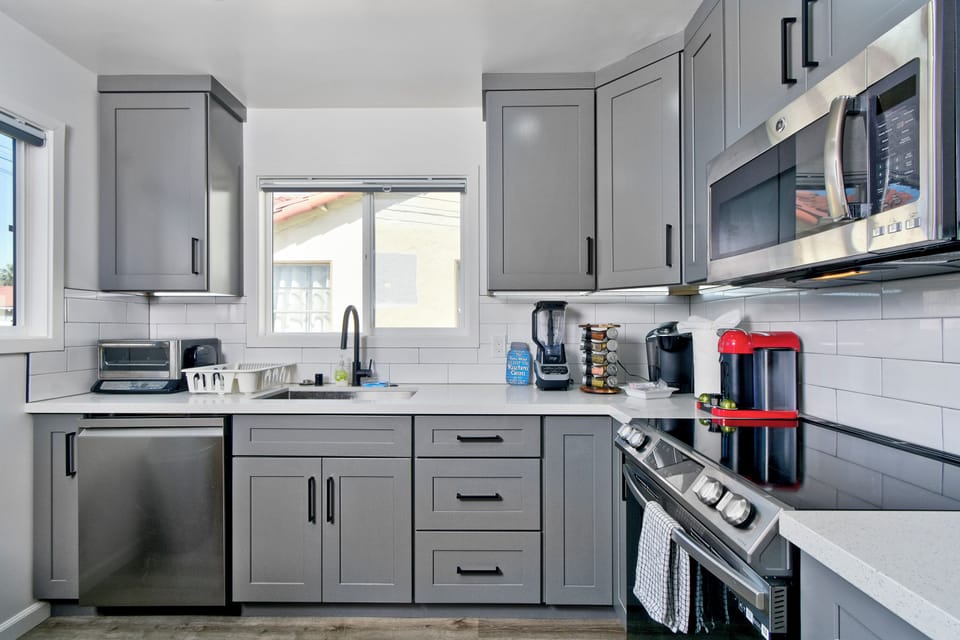 Unit A kitchen with stainless appliances and quartz counters