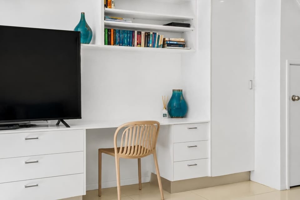 Settle into the dedicated workspace with built-in shelving and natural light, offering a practical spot to plan reef excursions, browse local dining options, or catch up online.