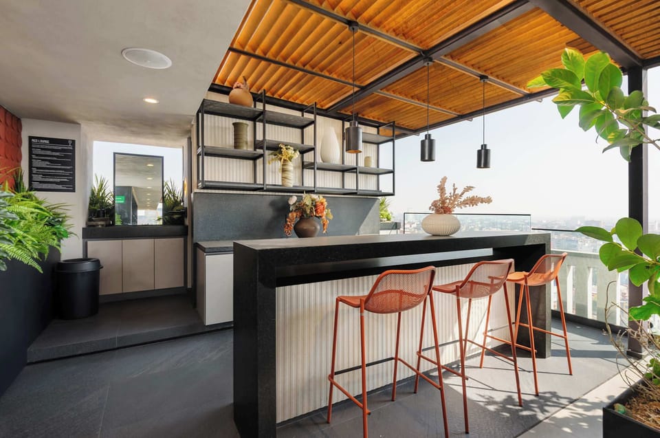 Rooftop dining area with bar seating, perfect for enjoying meals outdoors.