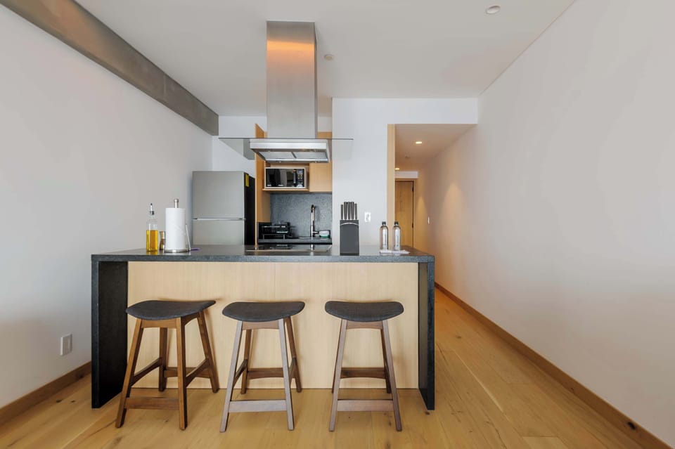 Convenient breakfast bar with high stools, perfect for enjoying coffee or a quick meal.
