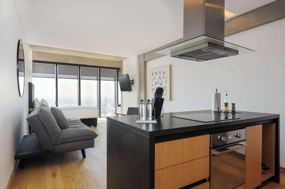 Modern living area seamlessly connected to a fully equipped kitchen, perfect for relaxing or preparing your favorite meals.