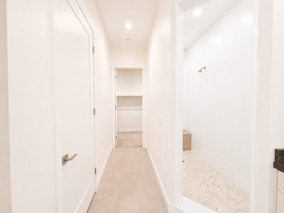 Primary bathroom leading to shower and closet