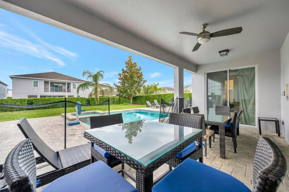 Outdoor entertaining area with plenty of seating and ceiling fan