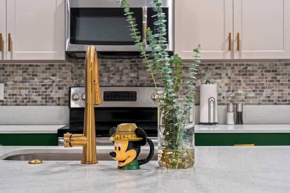 ✨ Kitchen Magic! A sleek and stylish space with gold accents and a playful touch of Disney charm! The perfect blend of elegance and personality to make every meal a little more magical.  #ModernKitchen #DisneyTouch #