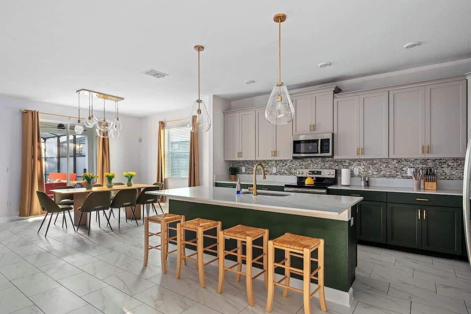 ✨ Open & Inviting! This stunning kitchen and dining area blend modern elegance with warm, earthy tones. Gold accents, sleek cabinetry, and natural wood details create a timeless, cozy vibe. Who's ready to cook & entertain? ️ #DreamKitchen 