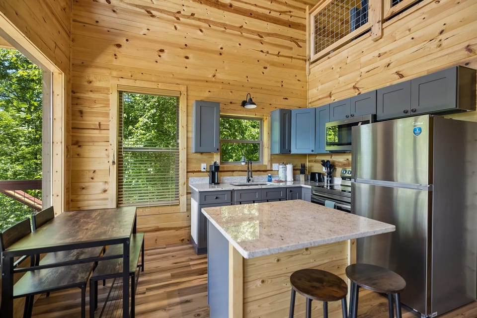 Kitchen: Bright and inviting kitchen with modern conveniences and cozy cabin charm, perfect for preparing meals after a day of exploring.