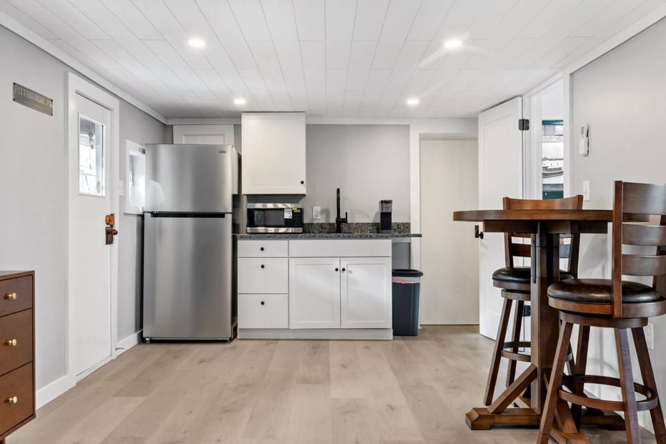 Wide view of the kitchenette and dining area within the open studio floor plan.